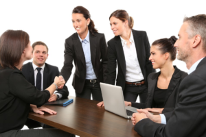 a group of people wearing black suits